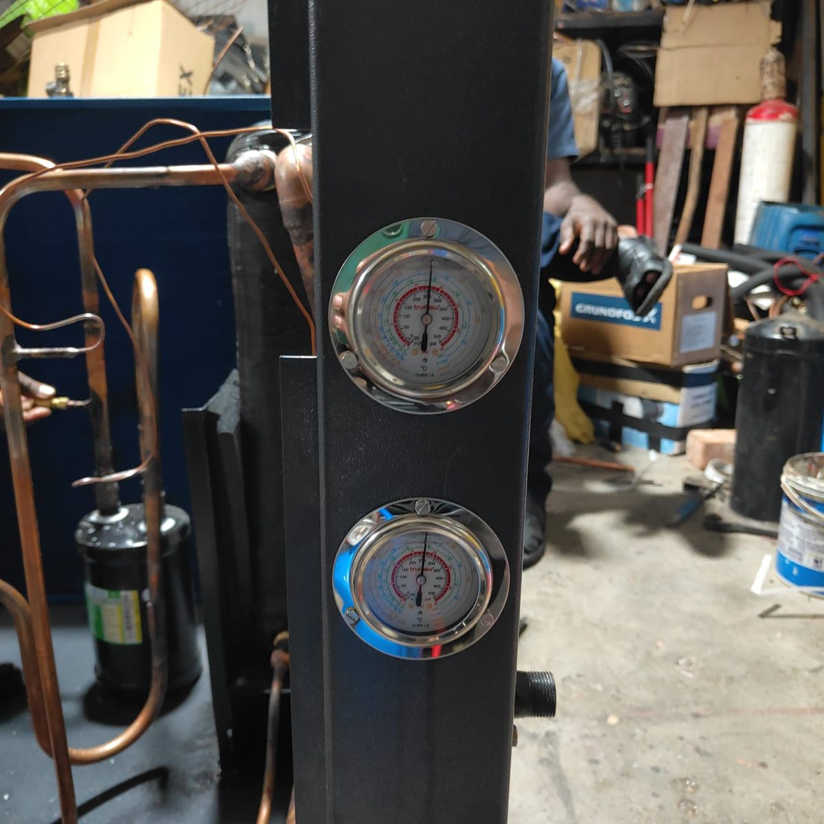 High and low pressure gauges and copper piping on an Energion heat-pump build